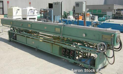 Used RDN Vacuum Sizing Tank, model 4D2V2T24, 304 stainless steel. 12" wide x 12" deep x 24' long. (4) sections with covers.  Includes holding tank, heat exchangers and pumps. Mounted on a carbon stee...