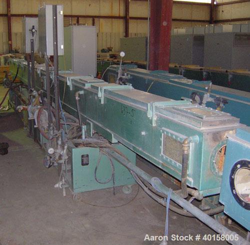 Used RDN Vacuum Sizing Tank, Model 4D3V2T30, stainless steel. 12" wide x 12" deep x 30' long. (5) sections with covers. Includes holding tank and pumps. Mounted on a carbon steel frame with casters.