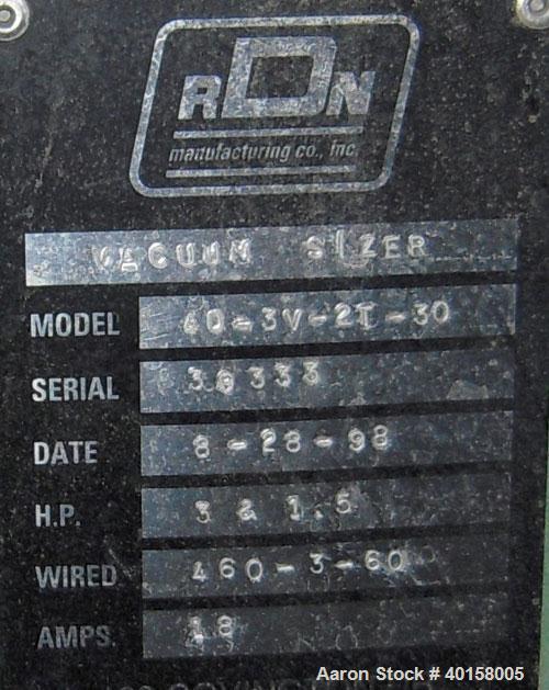 Used RDN Vacuum Sizing Tank, Model 4D3V2T30, stainless steel. 12" wide x 12" deep x 30' long. (5) sections with covers. Includes holding tank and pumps. Mounted on a carbon steel frame with casters.
