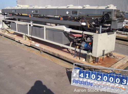 Used Conair Vacuum Sizing Tank, Model MT104-22-5, 304 Stainless Steel. 12" wide x 265" long x 7" deep. Includes a holding tank and pumps. Mounted on a carbon steel frame on casters.