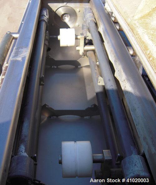 Used Conair Vacuum Sizing Tank, Model MT104-22-5, 304 Stainless Steel. 12" wide x 265" long x 7" deep. Includes a holding tank and pumps. Mounted on a carbon steel frame on casters.