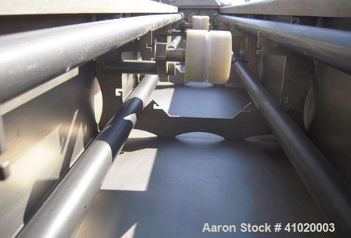 Used Conair Vacuum Sizing Tank, Model MT104-22-5, 304 Stainless Steel. 12" wide x 265" long x 7" deep. Includes a holding tank and pumps. Mounted on a carbon steel frame on casters.