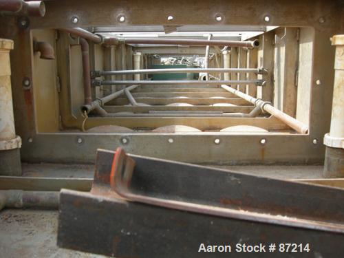 USED: Conair Metaplast vacuum sizing tank, stainless steel. 28" wide x 14' long x 13" deep. Includes (2) 5 hp pumps, (2) 2 hp centrifugal pumps, (3) piece top cover, (2) APV plate heat exchangers, ho...