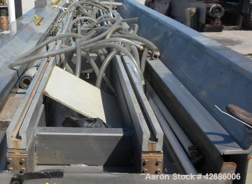 Used Crown Vacuum Calibrating Table, Model CMZDY. Stainless steel pan 24" wide x 231" long x approximately 3-3/4" deep. 2. The dies are connected with aluminum alloy “T” guiding rails and bolts. Incl...