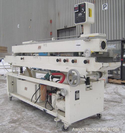 Used RDN Vacuum Sizer Tank, 304 Stainless Steel. 6" wide x 96" long x 6" deep, with holding tank, pump, and heat exchanger. Includes control panel, mounted on a carbon steel frame with casters, seria...