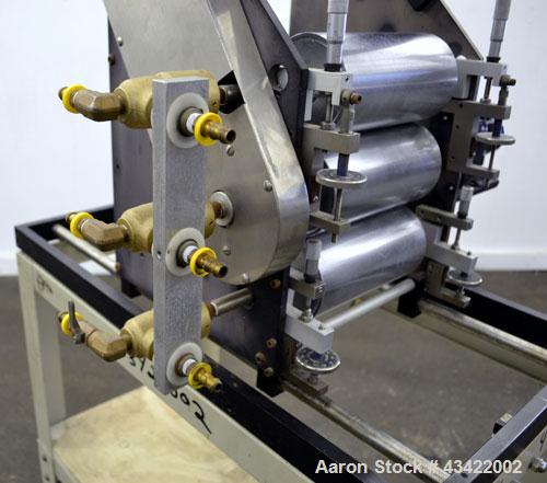 Used C.W. Brabender Univex Lab Take Off. Approximate capacity speeds of up to 30 meters per minute. Consisting of (3) 4” diameter x 8” wide chrome plated, manually adjustable cored rolls, and a top m...