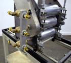 Used C.W. Brabender Univex Lab Take Off. Approximate capacity speeds of up to 30 meters per minute. Consisting of (3) 4” diameter x 8” wide chrome plated, manually adjustable cored rolls, and a top m...