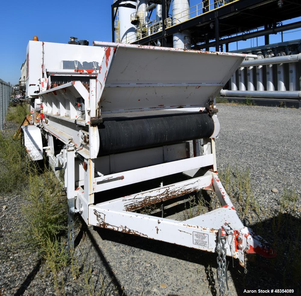 Used Diesel driven shredder trailer. With a 53" wide rotor, 54" wide infeed conveyor, 36" wide discharge conveyor, John Deere 6.8 liter PowerTech diesel engine. Mounted on a dual axel trailer.