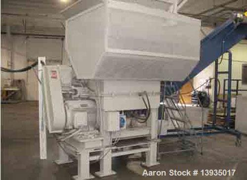 Used-EconoGrind single shaft shredder, model ESS 1200. Feed throat opening 55.9" x 49.4", rotor diameter 18", hyd ram, 100 h...