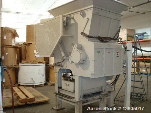 Used EconoGrind single shaft shredder, model ESS 1200. Feed throat opening 55.9" x 49.4", rotor diameter 18", hyd ram, 100 hp with controls.