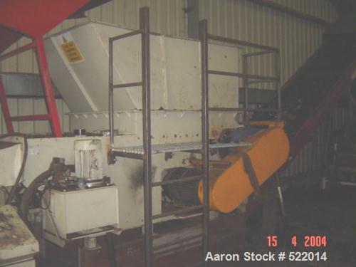 USED: Holzmag single roll shredder. Material of construction is carbon steel on product contact areas. 11.7" diameter x 46.8" straight side (300mm x 1200mm) single roll shredder with interchangeable ...