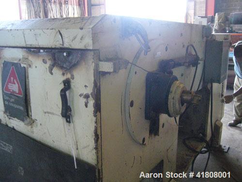 Used Uni-Shred Single Rotor Shredder, carbon steel. 63" x 67" feed. Hydraulic ram feeder. Shreddder driven by a 150 hp motor. Includes belt discharge conveyor.