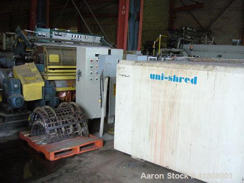 Used Uni-Shred Single Rotor Shredder, carbon steel. 63" x 67" feed. Hydraulic ram feeder. Shreddder driven by a 150 hp motor. Includes belt discharge conveyor.