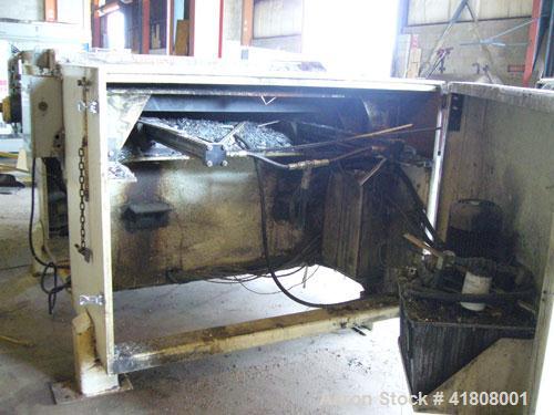 Used Uni-Shred Single Rotor Shredder, carbon steel. 63" x 67" feed. Hydraulic ram feeder. Shreddder driven by a 150 hp motor. Includes belt discharge conveyor.