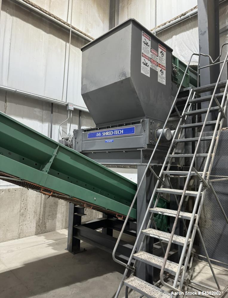 Used Shred-Tech Dual Shaft Shredder. With dual 30hp motor, feed hopper, stand, panel.