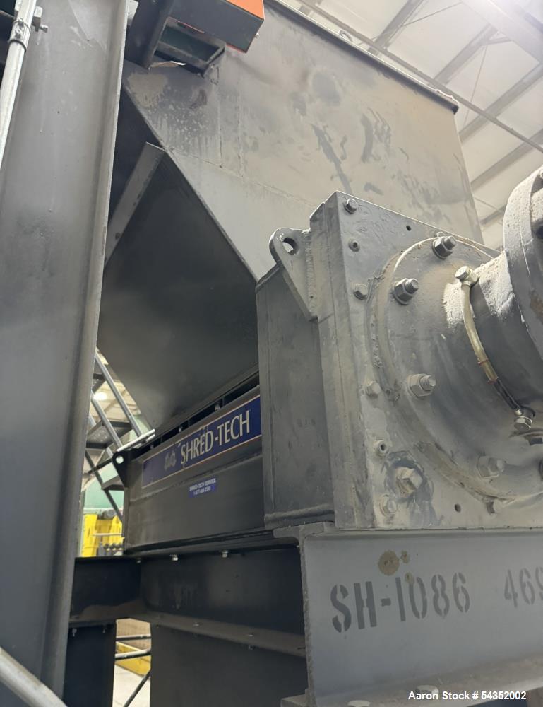 Used Shred-Tech Dual Shaft Shredder. With dual 30hp motor, feed hopper, stand, panel.