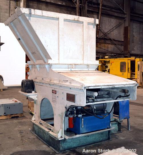 Used Vecoplan/Re-Tech Single Shaft Shredder, Carbon Steel. Approximately 14” diameter x 42” wide rotor with bolt-on cutters. Approximate 44” x 49” feed opening with bolt on hopper. Dual ram horizonta...