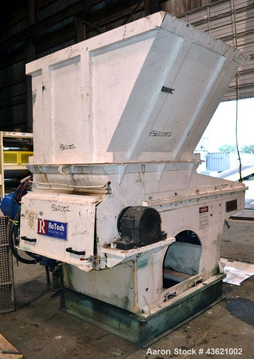 Used Vecoplan/Re-Tech Single Shaft Shredder, Carbon Steel. Approximately 14” diameter x 42” wide rotor with bolt-on cutters. Approximate 44” x 49” feed opening with bolt on hopper. Dual ram horizonta...