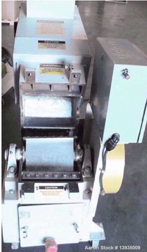 Used Battenfeld Gloucester 1012-BP-10. 10" x 12" throat size opening, 10 hp, 2 rotor knives, 1 bed knife, 230V, includes conveyor.