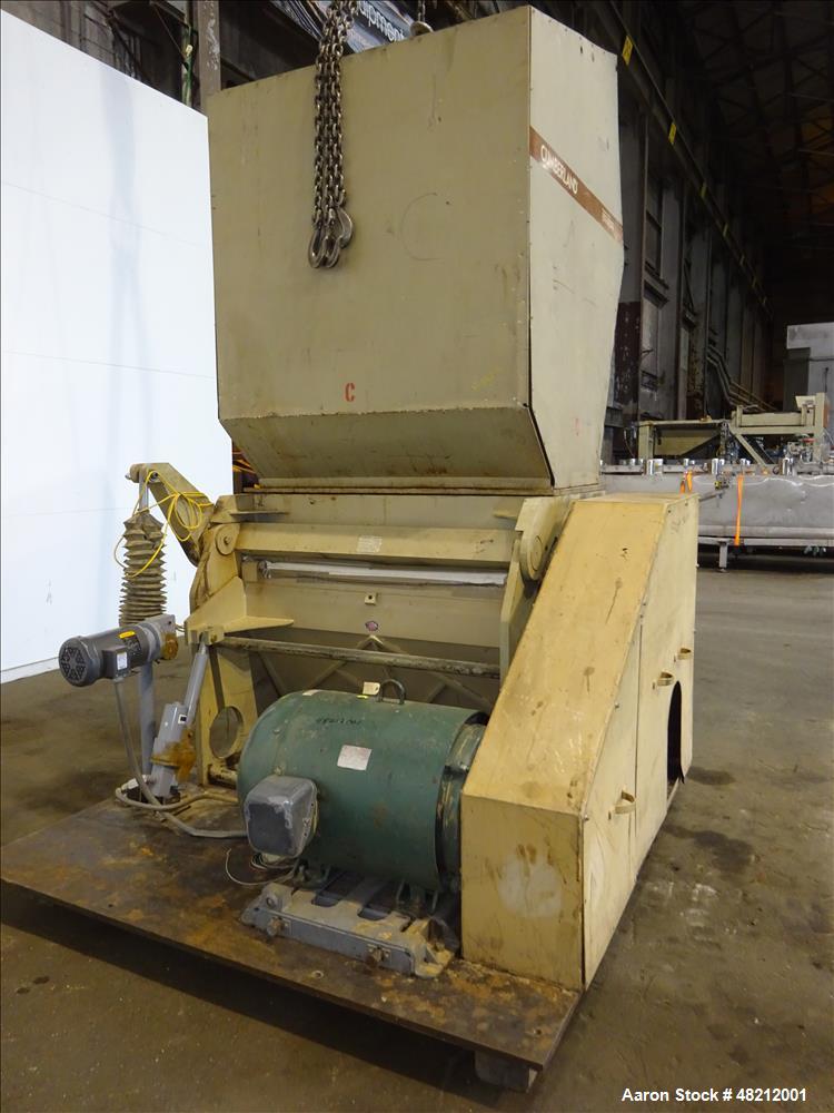 Used Cumberland X-Series  Granulator,  Model X1400. Approximate 24" x 56" feed throat with a tilting feed hopper. 5 Knife twin shear / high shear rotor, 2 bed knife, belt driven by a 150 hp 3/60/460 ...