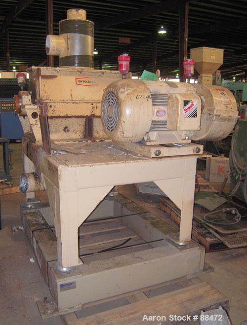 Used Entoleter Film Grinder, Model 1530F. Approximate 15" diameter x 30" wide 7 blade open rotor. Approximately 8" x 30" feed throat with a film hopper, set up for bottom blower discharge. Approximat...