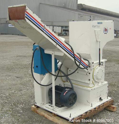 Used MPG Granulator, Model GP-1220HB. Approximately 10" diameter x 24" wide, 3 rows of 2 bolt on slanted blade open rotors. Tilt back pelican style feed hopper with sheet feed, set up for blower disc...