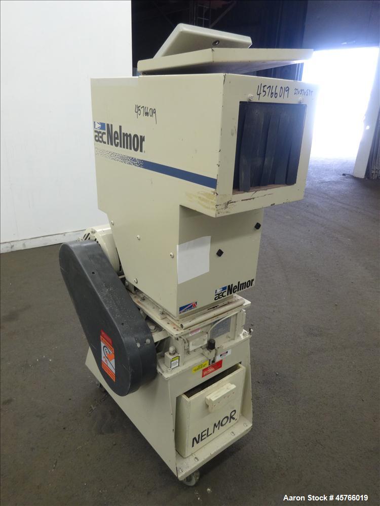 Used AEC Nelmor Grinder, Model G810P1. Tilt back hopper, open rotor with 3 bolt on blades, 9-1/2" long driven by a 7.5 hp, 3/60/208-230/460 volt, 1745 rpm motor. Screen has 5/16" diameter holes. Bott...