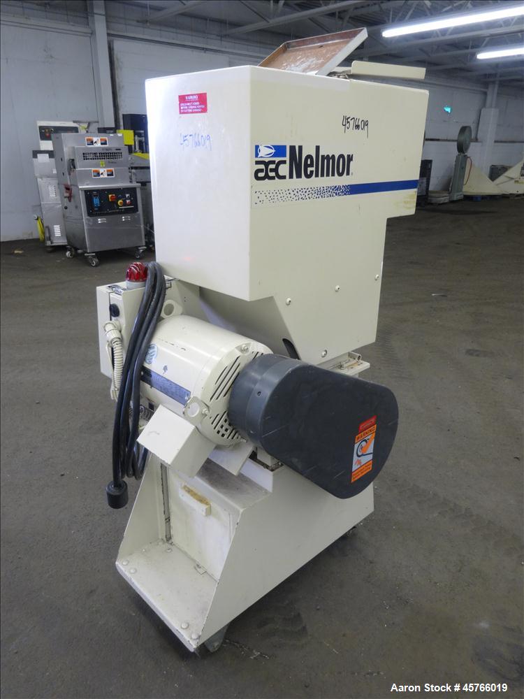 Used AEC Nelmor Grinder, Model G810P1. Tilt back hopper, open rotor with 3 bolt on blades, 9-1/2" long driven by a 7.5 hp, 3/60/208-230/460 volt, 1745 rpm motor. Screen has 5/16" diameter holes. Bott...