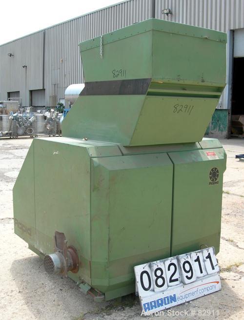 USED: Rapid granulator, model 1824K. Approx 18" diameter x 24" wide open rotor with 3 rows of 2 bolt on blades. Tilt back pelican style feed hopper, set up for blower discharge. Driven by an approx 2...