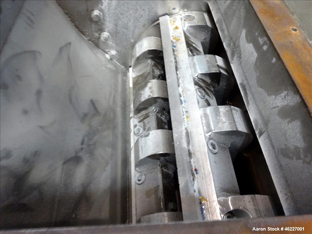 Used Tria Granulator, Carbon Steel. Approximate 20" x 26" feed throat with a bolt on feed hopper. Approximate (4) rows bolt on blades, open rotor, set up for bottom blower discharge with a 2.2kw blow...