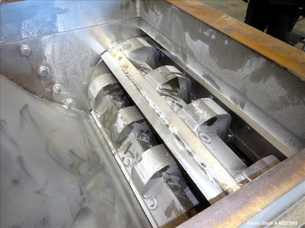 Used Tria Granulator, Carbon Steel. Approximate 20" x 26" feed throat with a bolt on feed hopper. Approximate (4) rows bolt on blades, open rotor, set up for bottom blower discharge with a 2.2kw blow...