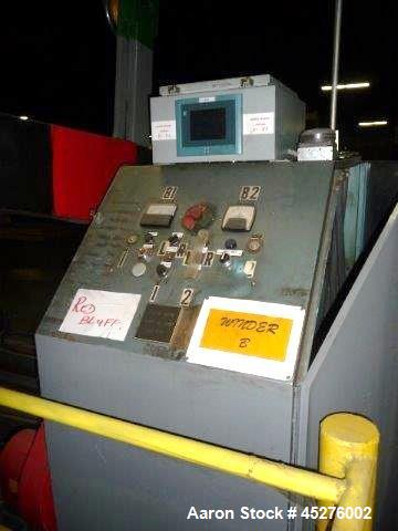 Used Crown 76" Wide Turret Winder. Up to 60" OD roll size, 2000# capacity, 4 position, single turret with motor drive.