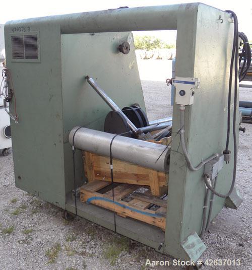 Used Johnson Plastics Machinery Dual Turret Winder, Approximately 36" wide. (1) Adjustable guide roll. Each roll driven by an approximate 2hp motor. Includes control panel. Mounted on casters.
