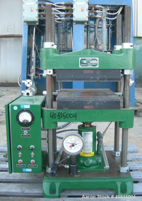 Used Carver Manual Hydraulic Press, 12 Ton, Model 2696.  Hand operated for 0-12 tons (24,000 pounds).  (2) 12" x 12" electrically heated, water cooled platens.  Ram stroke 5.1", daylight opening 1" t...