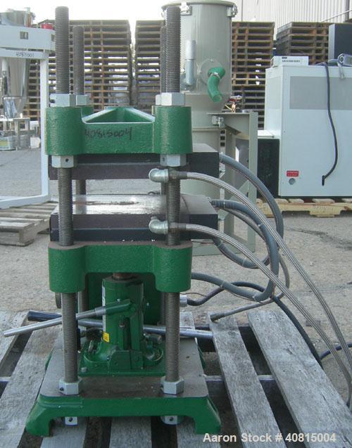 Used Carver Manual Hydraulic Press, 12 Ton, Model 2696.  Hand operated for 0-12 tons (24,000 pounds).  (2) 12" x 12" electrically heated, water cooled platens.  Ram stroke 5.1", daylight opening 1" t...