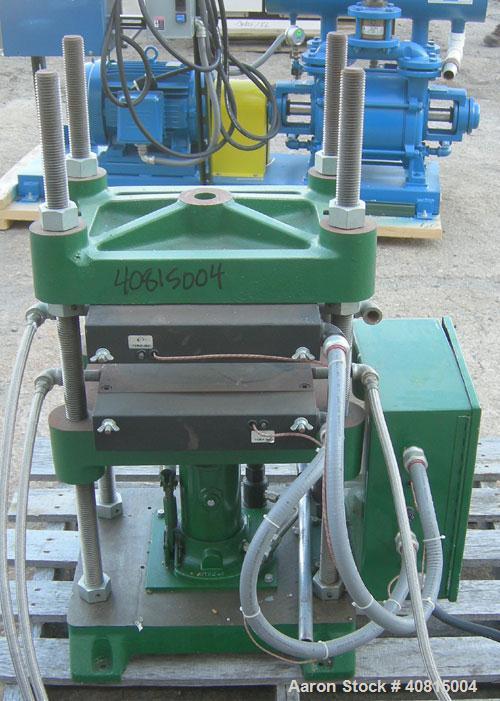 Used Carver Manual Hydraulic Press, 12 Ton, Model 2696.  Hand operated for 0-12 tons (24,000 pounds).  (2) 12" x 12" electrically heated, water cooled platens.  Ram stroke 5.1", daylight opening 1" t...