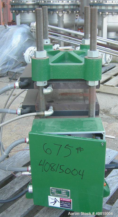 Used Carver Manual Hydraulic Press, 12 Ton, Model 2696.  Hand operated for 0-12 tons (24,000 pounds).  (2) 12" x 12" electrically heated, water cooled platens.  Ram stroke 5.1", daylight opening 1" t...