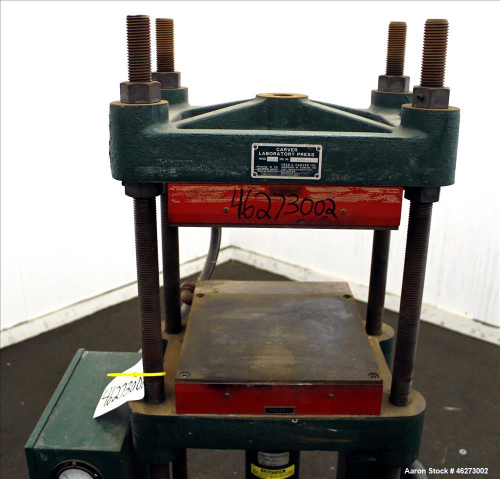 Used Carver Laboratory Manual Press, Model 2699, 30 Ton Clamping Force. Hydraulic, 4 post upstroke type. (2) 12" long x 12" wide electrically heated platens. Maximum temperature 650 degrees F. 6" Str...