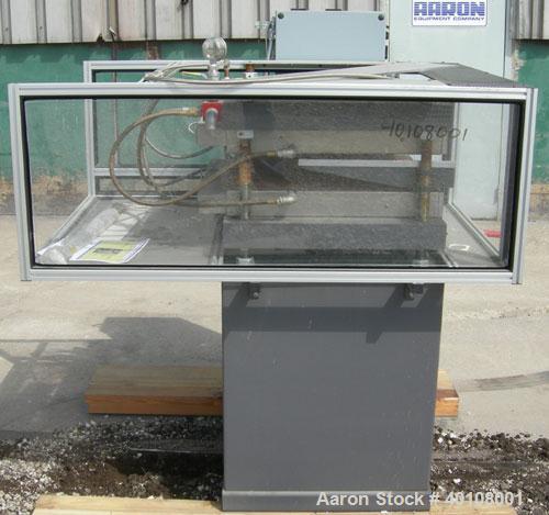 Used:  Carver 4 Post Manual Hydraulic Press, Model 4902. 30 ton clamp force capacity.  (2) 24" x 24" electrically heated, water cooled platens, rated to 650 degrees F.  6" ram stroke, 1-4" daylight o...