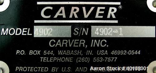 Used:  Carver 4 Post Manual Hydraulic Press, Model 4902. 30 ton clamp force capacity.  (2) 24" x 24" electrically heated, water cooled platens, rated to 650 degrees F.  6" ram stroke, 1-4" daylight o...