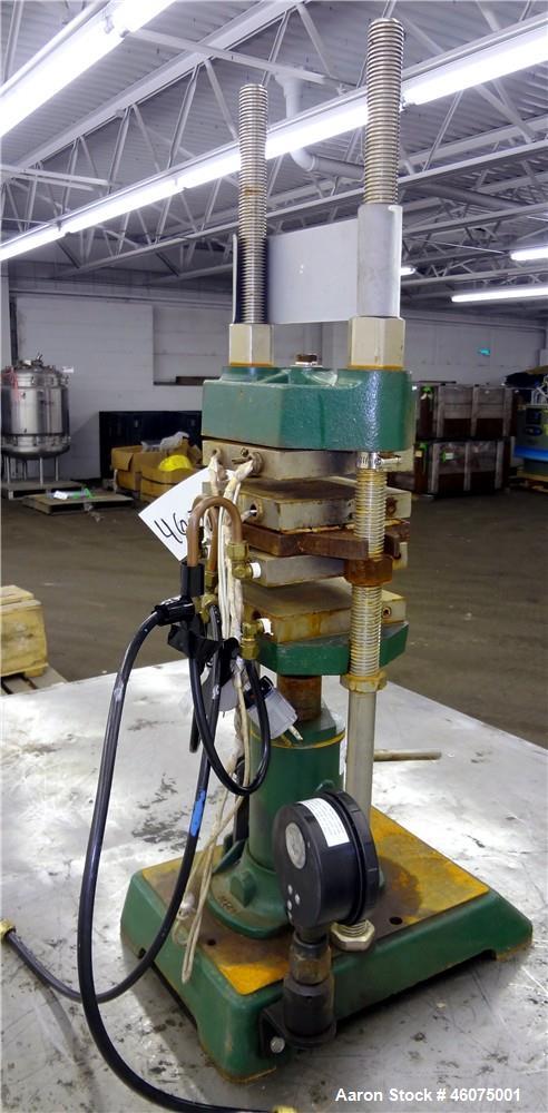 Used Carver Manual (2) Column Hydraulic Laboratory Press, 12 Ton Clamping Force, Model C. (2) 6" Wide x 6" long electrically heated platens, (2) 6" wide x 6" long water cooled platens. Maximum temper...