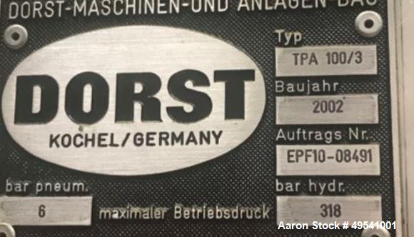 Used Dorst Hydraulic Press, Model TPA 100, 100-ton press. Reportedly rebuilt by Dorst to CE norm with a PQC in Year 2002. Year 1987.