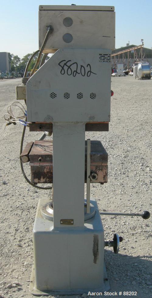 USED: PHI manual compression press, approximate 50 ton. Up acting cylinder. 12-1/2" x 12-1/2" electrically heated platens. Approximate 6" to 10" adjustable daylight. 0-6" stroke. Includes control pan...