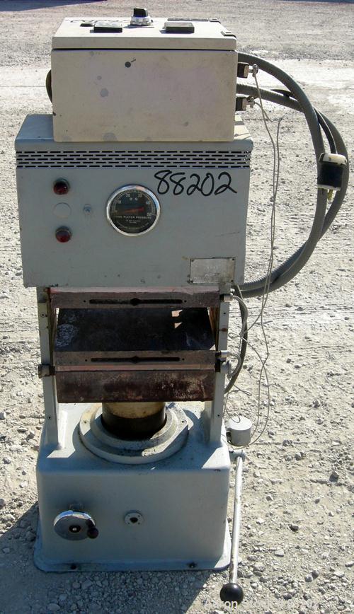 USED: PHI manual compression press, approximate 50 ton. Up acting cylinder. 12-1/2" x 12-1/2" electrically heated platens. Approximate 6" to 10" adjustable daylight. 0-6" stroke. Includes control pan...