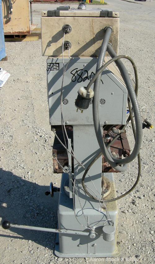 USED: PHI manual compression press, approximate 50 ton. Up acting cylinder. 12-1/2" x 12-1/2" electrically heated platens. Approximate 6" to 10" adjustable daylight. 0-6" stroke. Includes control pan...