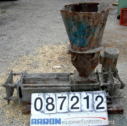 USED: Screw press, carbon steel. Approximate 6" diameter x 21" long chamber. 4" top feed with hopper. Screw driven by a 3/4 HP, 3/60/209-230/460 volt, 1725 RPM gear motor. Base mounted.