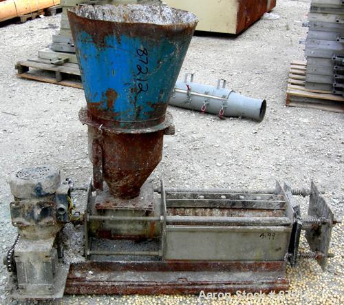 USED: Screw press, carbon steel. Approximate 6" diameter x 21" long chamber. 4" top feed with hopper. Screw driven by a 3/4 HP, 3/60/209-230/460 volt, 1725 RPM gear motor. Base mounted.
