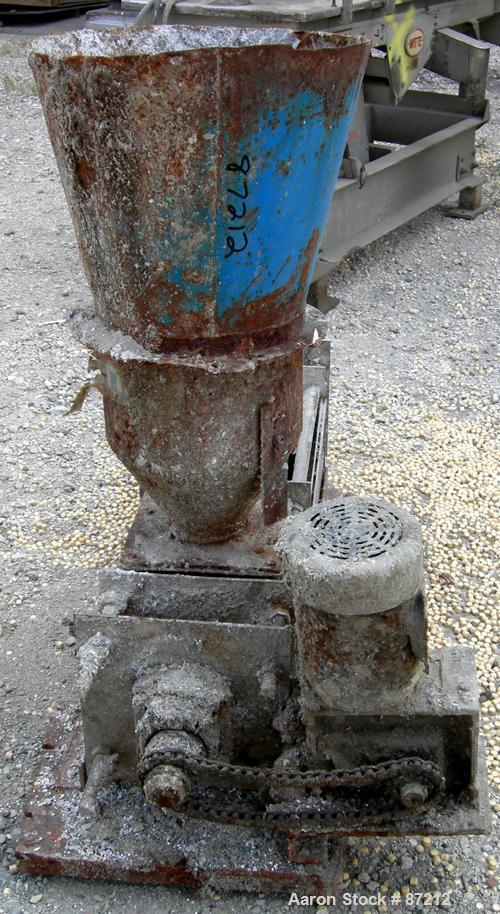 USED: Screw press, carbon steel. Approximate 6" diameter x 21" long chamber. 4" top feed with hopper. Screw driven by a 3/4 HP, 3/60/209-230/460 volt, 1725 RPM gear motor. Base mounted.