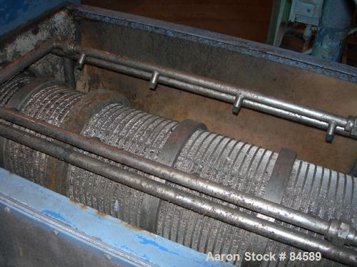 Used Pondorf Screw Press, 304 Stainless Steel. Approximate 12" diameter x 48" long screw. Driven by a 7.5 HP, 3/60/460 Volt, 1680 RPM varispeed gearmotor. Includes a carbon steel feed tank with a con...