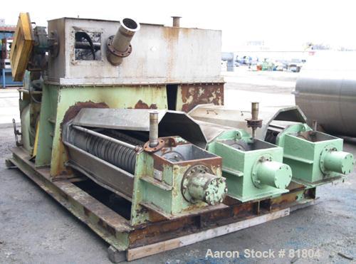 USED: Vetter Triple Screw Press, 316 stainless steel. (3) approximately 14" diameter x 6' long tapered screws, each driven by a 20 hp, 3/60/230/460 volt, 1750 rpm motor thru reducers, ratio 87:1. Top...